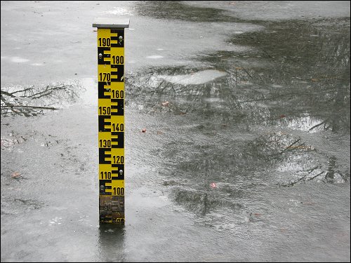 Pegelstab in zugefrorenem Kanal beim Lexikaliker um die Ecke