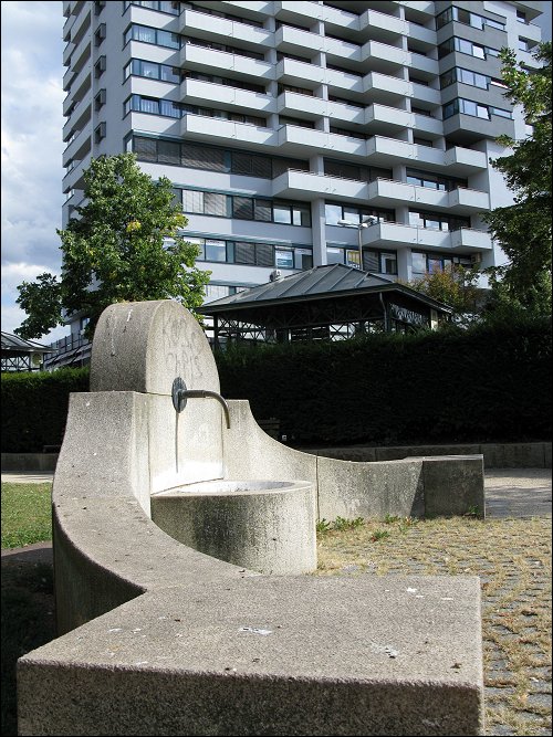 Brunnen und Bahnhofshochhaus in einer Linie