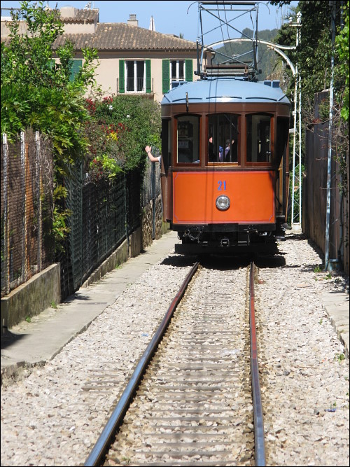 Straßenbahn in Sóller auf eng gefaßter Trasse zwischen zwei Garten-Grundstücken